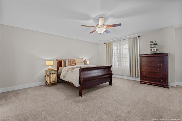 carpeted bedroom featuring ceiling fan and baseboards