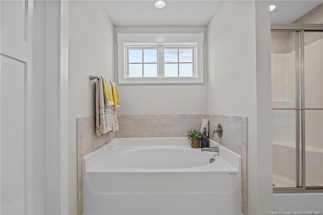 full bathroom featuring a shower stall and a bath