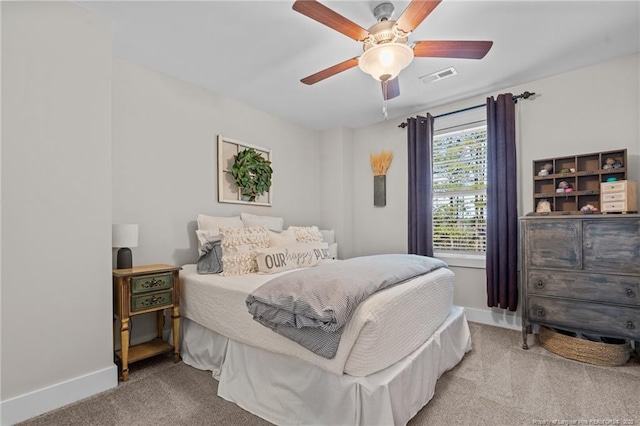 bedroom featuring carpet floors, visible vents, and baseboards