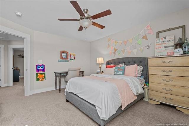 carpeted bedroom featuring attic access, a ceiling fan, and baseboards