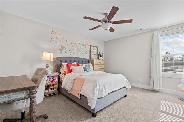 carpeted bedroom with baseboards, visible vents, and a ceiling fan