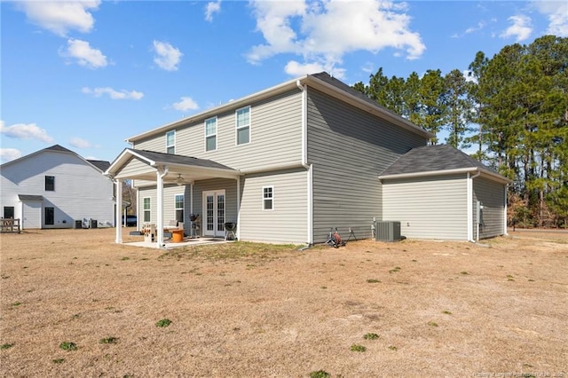 back of property featuring a patio area, central AC, a lawn, and french doors