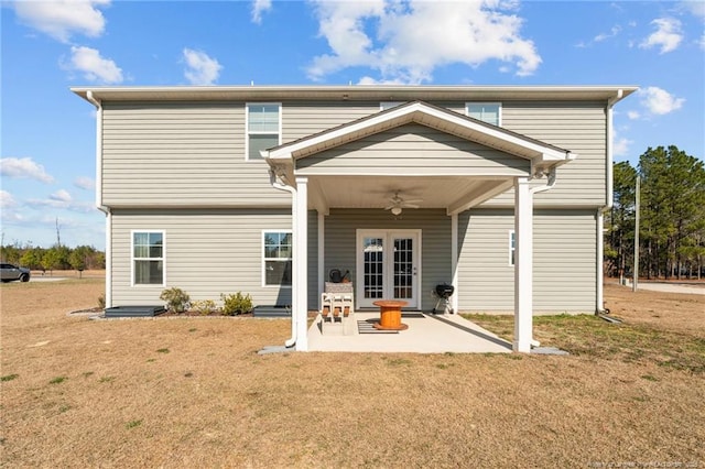 rear view of house featuring a yard, a patio, french doors, and a ceiling fan