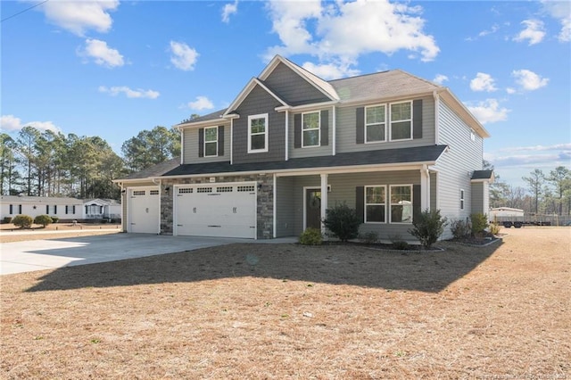 view of front facade featuring a garage, concrete driveway, and stone siding