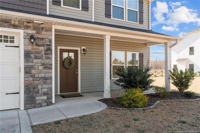 property entrance with stone siding and covered porch