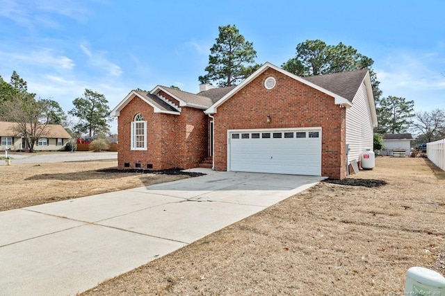 ranch-style home with brick siding, a chimney, a shingled roof, concrete driveway, and crawl space