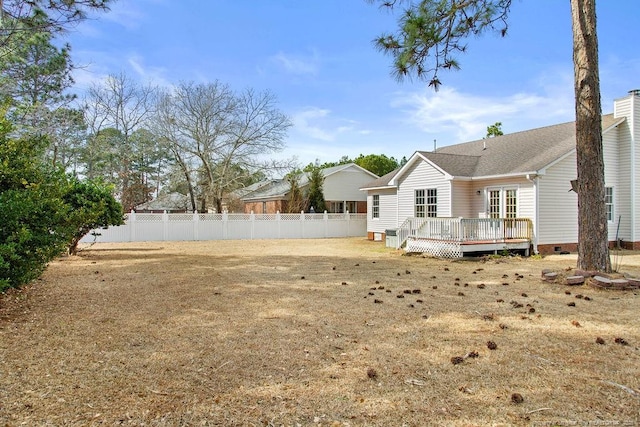 view of yard featuring fence and a wooden deck