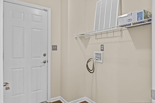 laundry area with laundry area, baseboards, and washer hookup