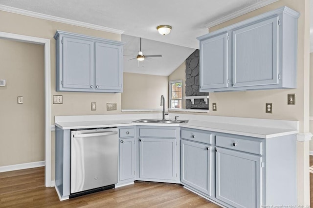 kitchen with light countertops, a ceiling fan, a sink, wood finished floors, and dishwasher