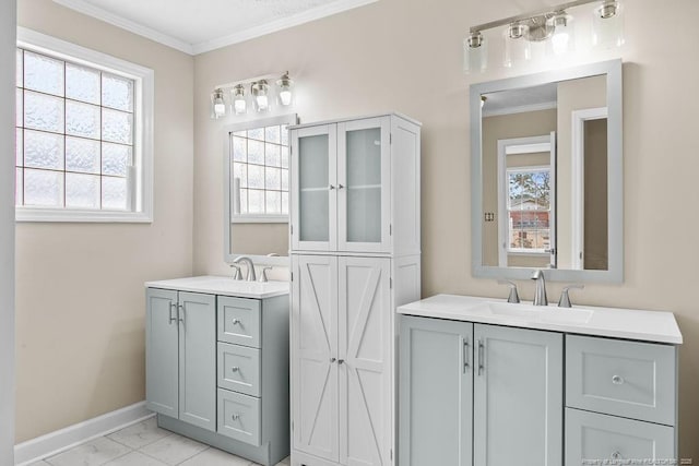 full bath with plenty of natural light, a sink, and crown molding