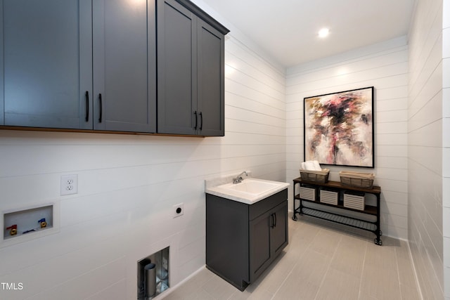 clothes washing area featuring recessed lighting, washer hookup, a sink, cabinet space, and electric dryer hookup