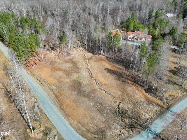 birds eye view of property featuring a wooded view