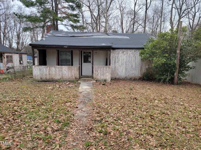 view of front of property featuring fence and a chimney