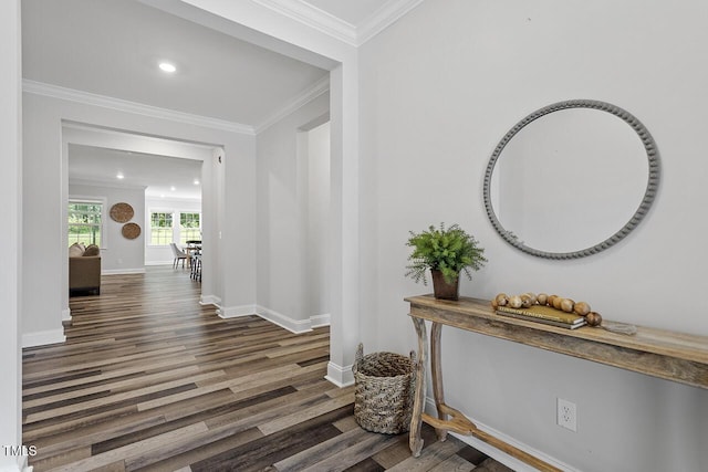 hallway featuring baseboards, recessed lighting, wood finished floors, and crown molding