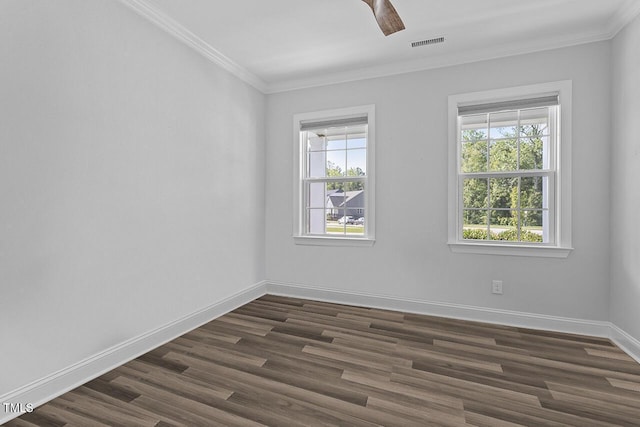 unfurnished room featuring a wealth of natural light, visible vents, and crown molding