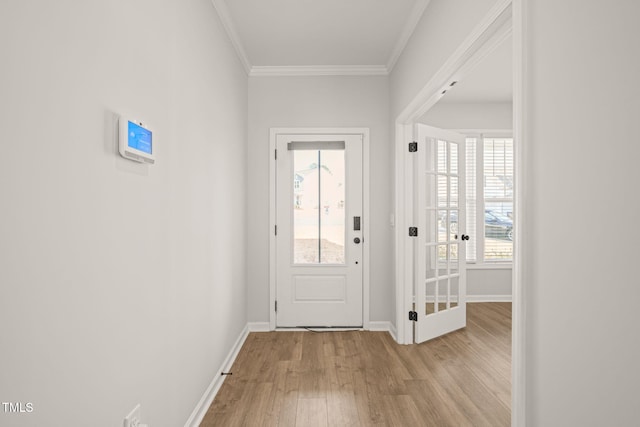 doorway featuring baseboards, light wood-style floors, and crown molding