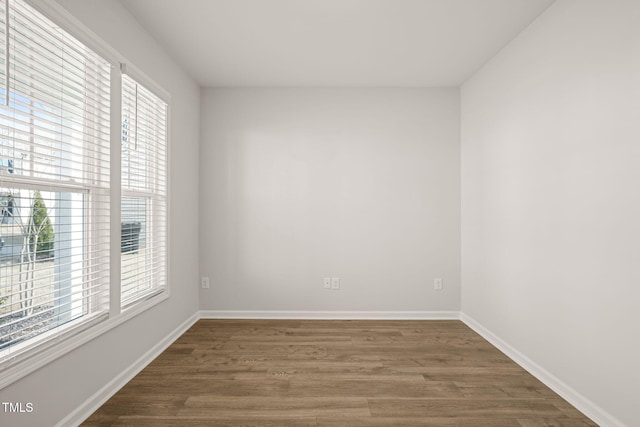 unfurnished room with wood finished floors and baseboards