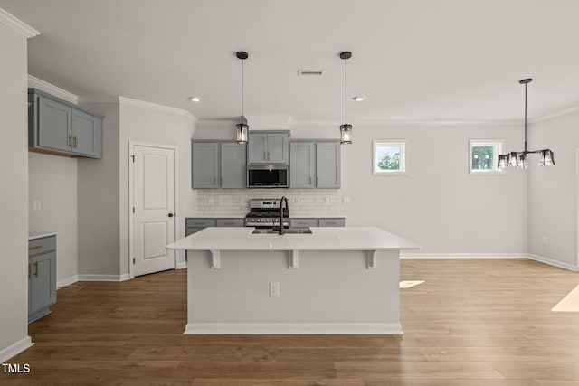 kitchen with a sink, stainless steel appliances, gray cabinets, and visible vents