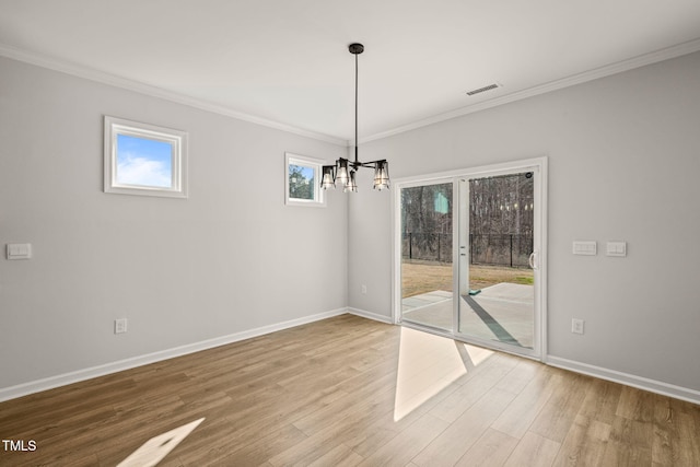 unfurnished dining area with ornamental molding, wood finished floors, visible vents, and baseboards