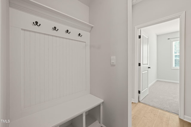 mudroom with light wood-style floors and baseboards