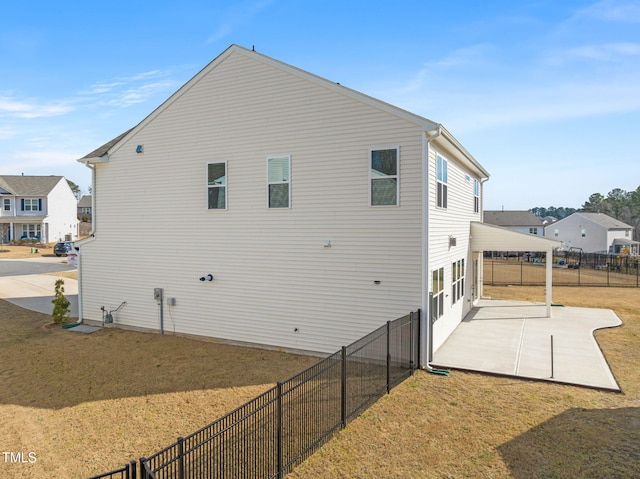 rear view of property with a patio, a yard, and fence