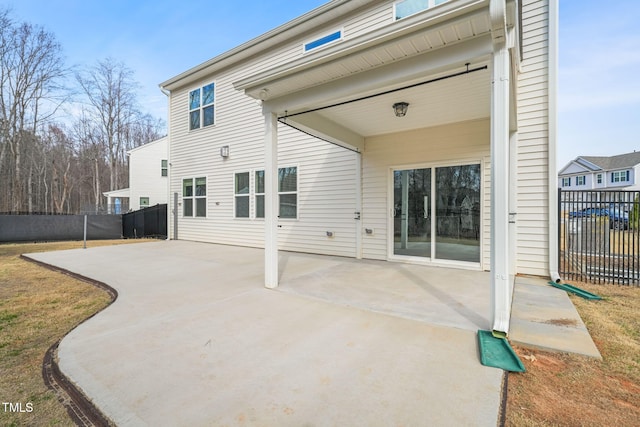 back of property featuring a patio and fence