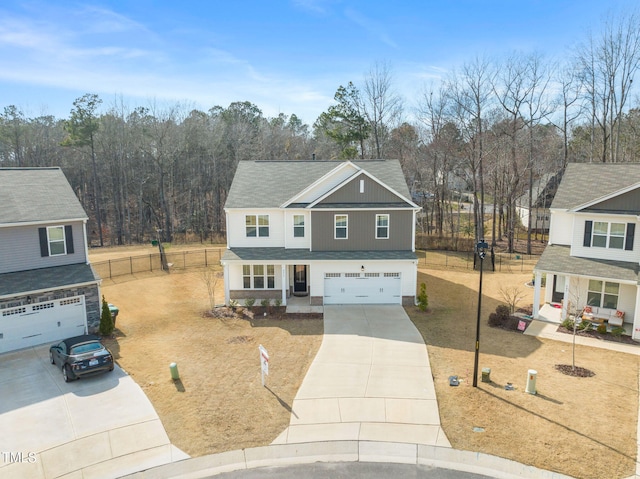 traditional-style home featuring a garage, covered porch, a shingled roof, fence, and driveway