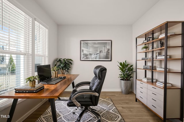 office with light wood-type flooring and baseboards