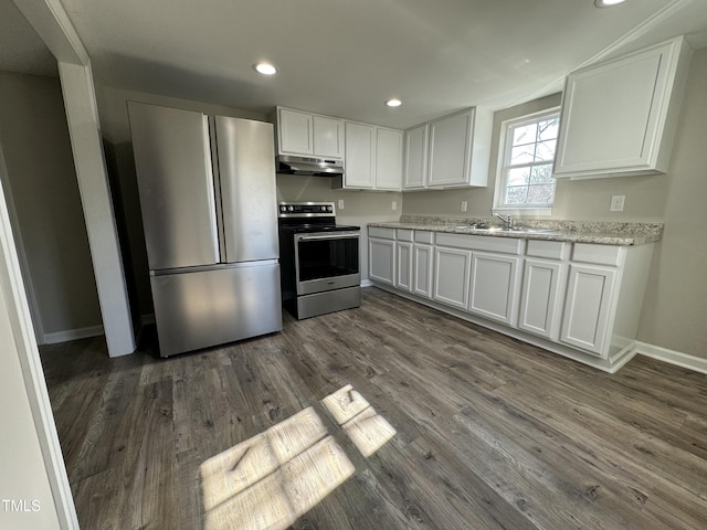 kitchen featuring recessed lighting, dark wood-style flooring, white cabinets, under cabinet range hood, and appliances with stainless steel finishes