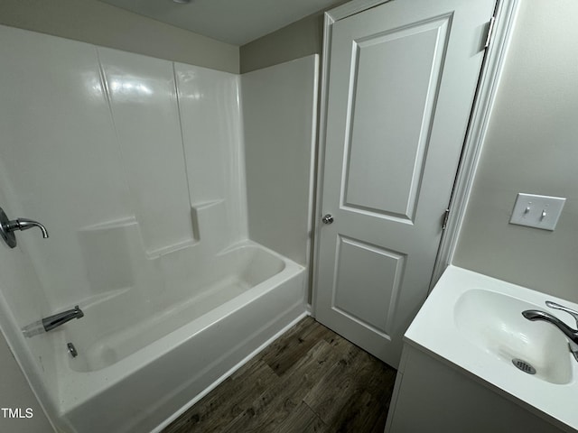 full bathroom with shower / bathtub combination, wood finished floors, and vanity