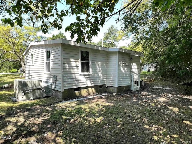 view of property exterior featuring crawl space and cooling unit