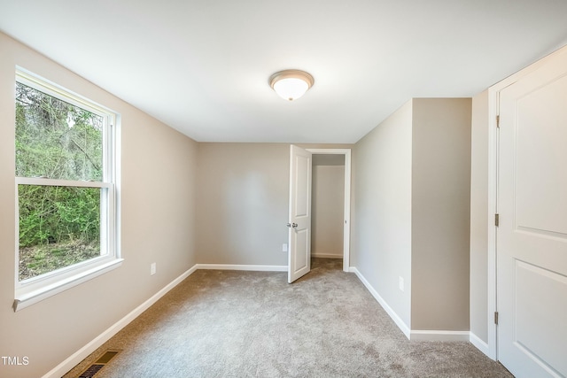 501 N 14th St, Erwin, NC 28339 - unfurnished room featuring carpet flooring, baseboards, visible vents, and a wealth of natural light