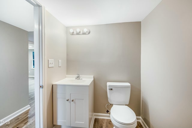 501 N 14th St, Erwin, NC 28339 - half bathroom with baseboards, toilet, wood finished floors, and vanity