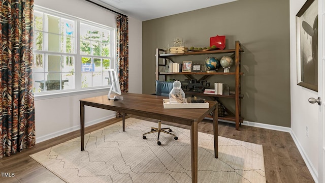 office area with baseboards and wood finished floors