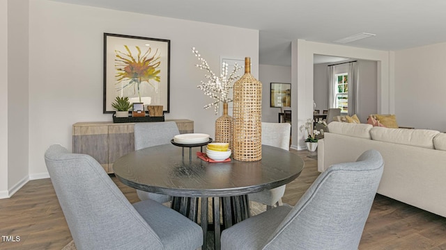 dining room with visible vents, baseboards, and wood finished floors