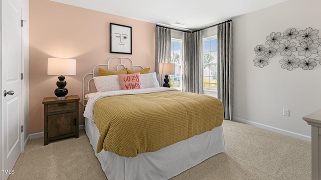 bedroom featuring baseboards and light colored carpet