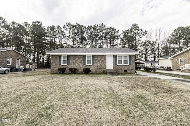 view of front facade featuring brick siding and a front yard