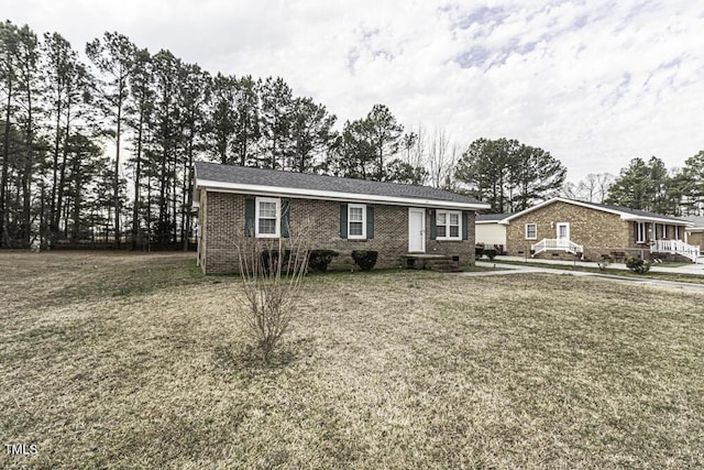 ranch-style house with a front yard and brick siding