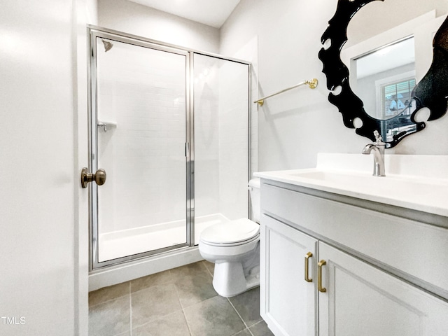 bathroom featuring vanity, a stall shower, tile patterned flooring, and toilet