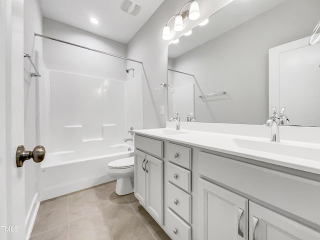 bathroom with double vanity, toilet, tub / shower combination, a sink, and tile patterned floors