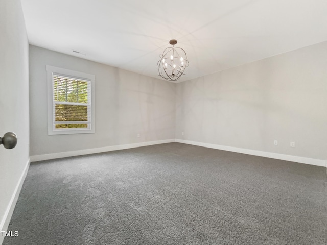 spare room featuring visible vents, baseboards, carpet flooring, and a chandelier