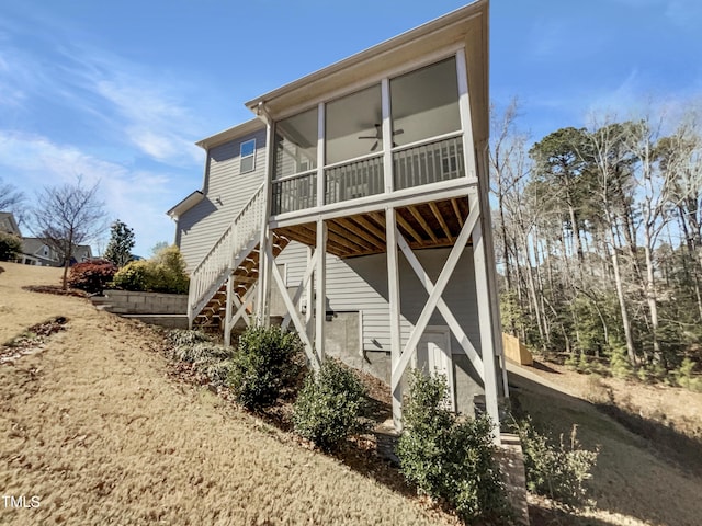 back of house with a sunroom and stairs