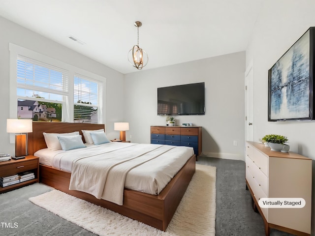 carpeted bedroom featuring visible vents, baseboards, and a notable chandelier