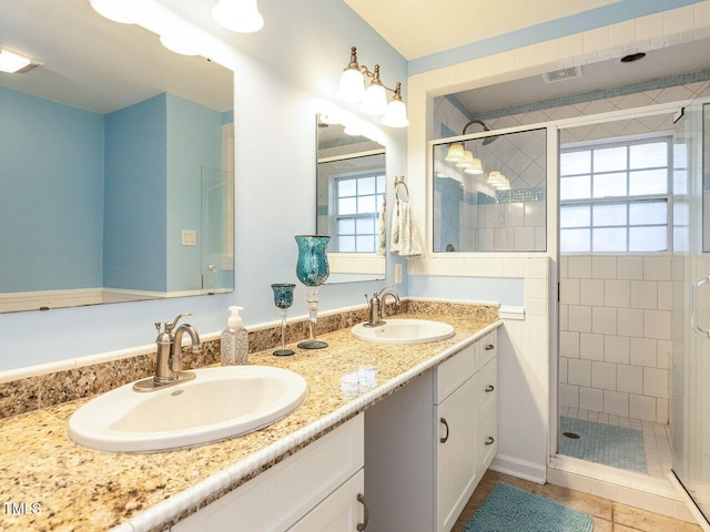 bathroom featuring a stall shower and a sink