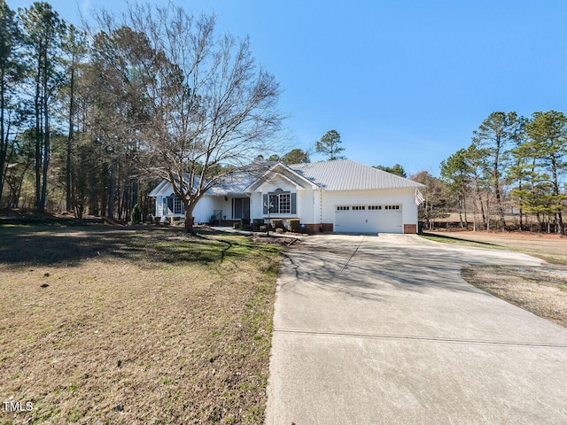 single story home featuring a garage, concrete driveway, and a front lawn