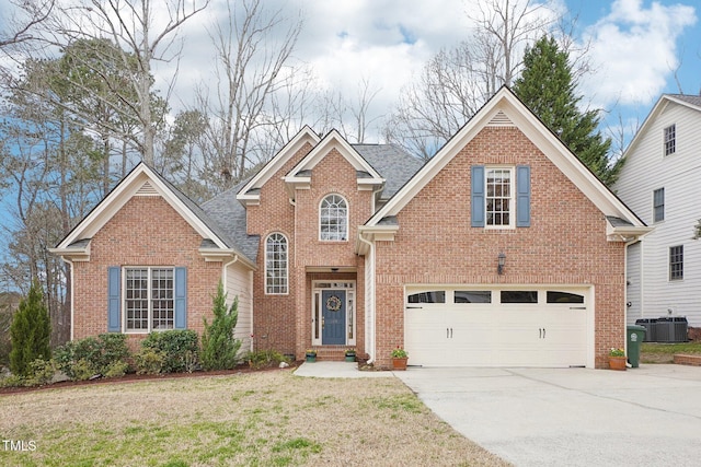 traditional home featuring brick siding, central AC, concrete driveway, and a front yard