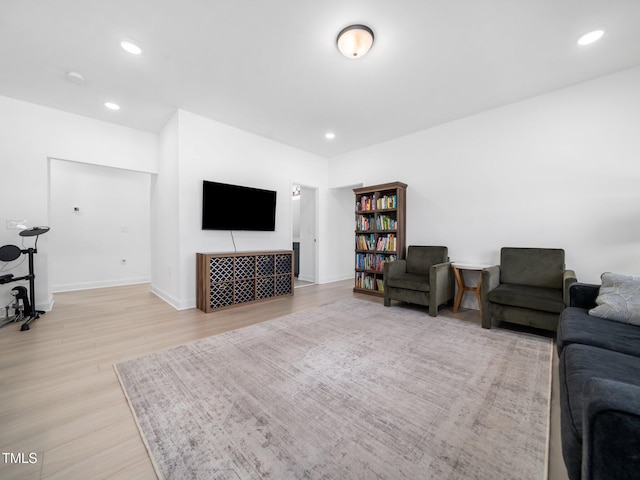 living room with baseboards, light wood finished floors, and recessed lighting