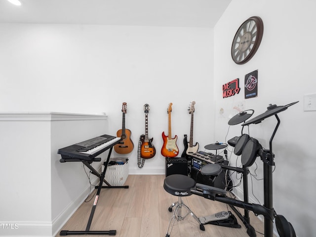 exercise area featuring baseboards and wood finished floors