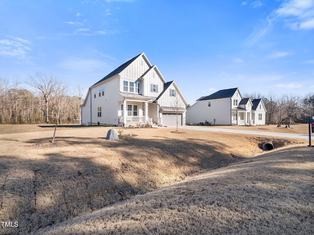 view of front of property with a standing seam roof, metal roof, board and batten siding, and an attached garage