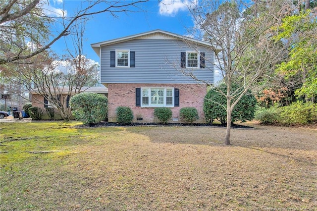 view of front of home with crawl space, brick siding, and a front lawn